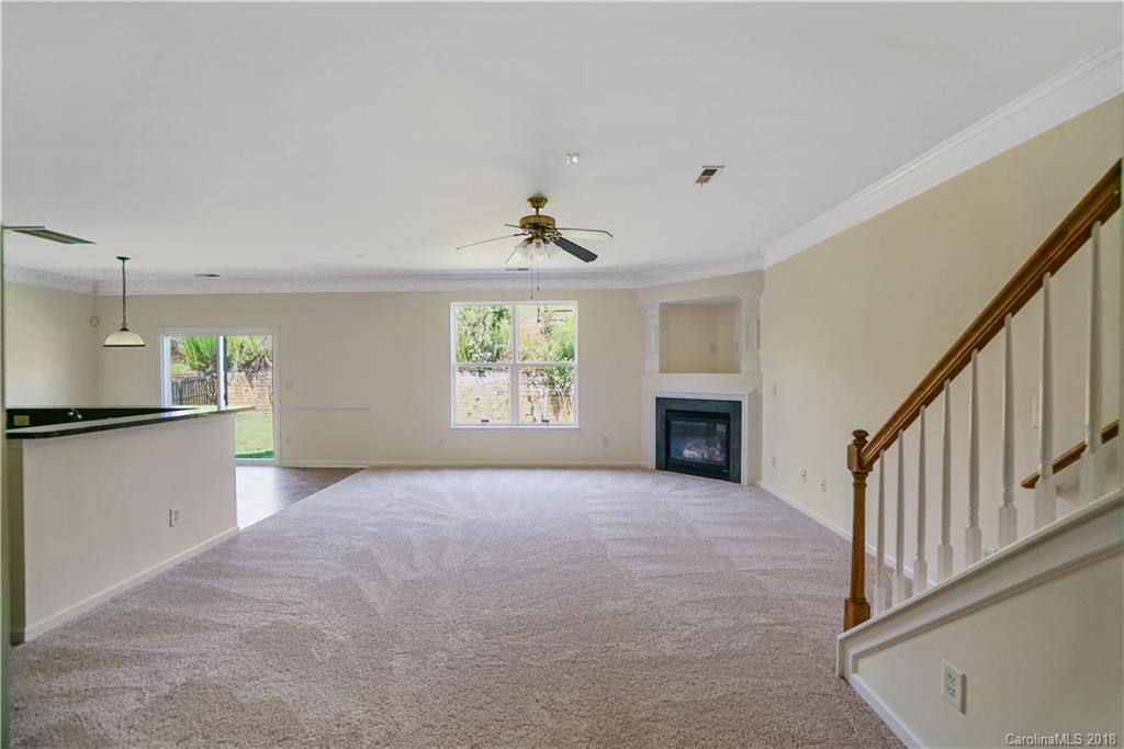 12918 Rothe House Road Charlotte, NC 28273 - Photo 10 of 25 a view of an empty room with a window and fireplace