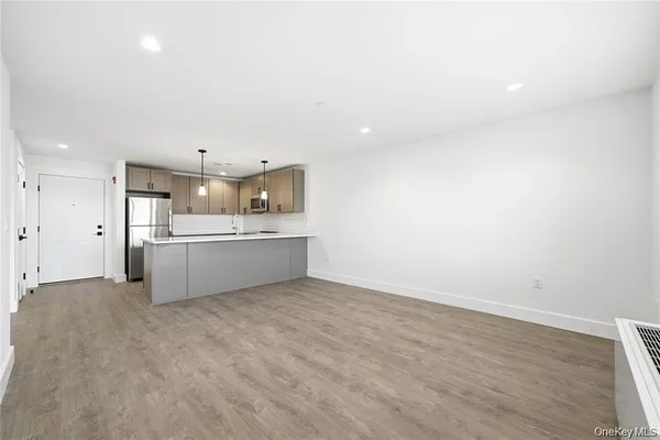a view of a kitchen with a sink and dishwasher a refrigerator with wooden floor