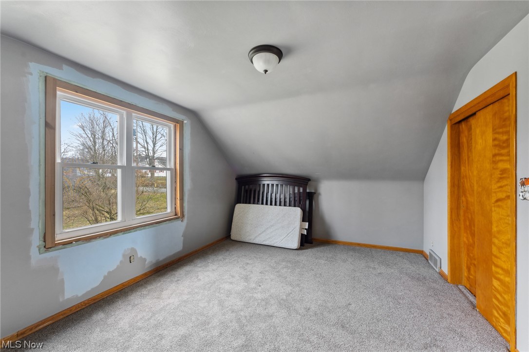 1470 Collar Price Road Hubbard, OH 44425 - Photo 17 of 23 Unfurnished bedroom with a closet, light colored carpet, and lofted ceiling