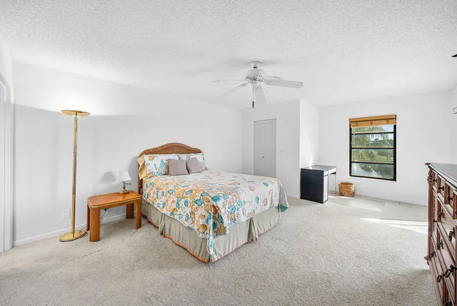 a view of a swimming pool with a garden and seating area
