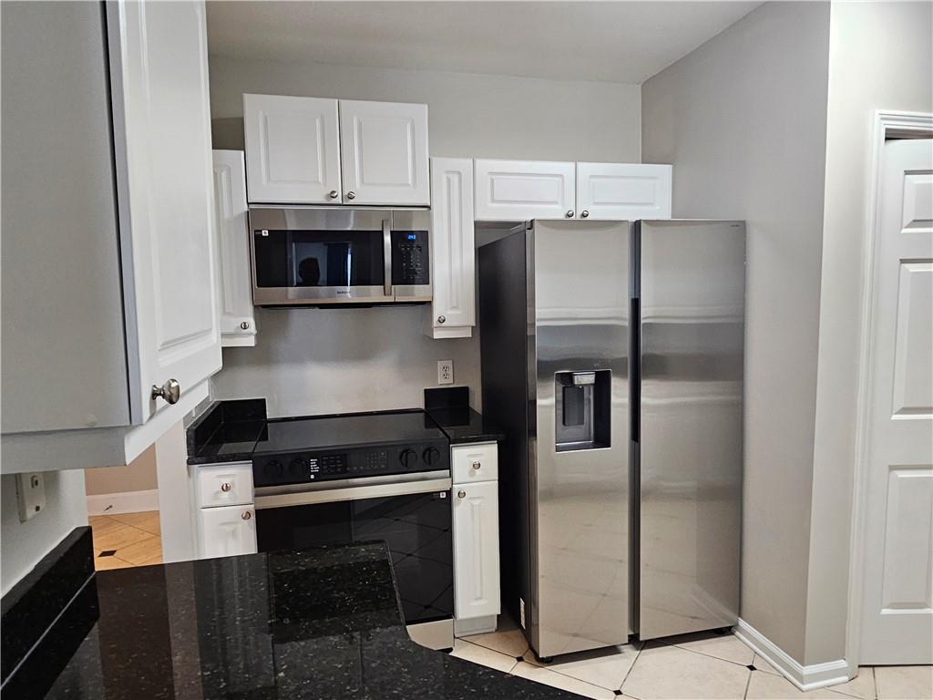 3334 Peachtree Road Northeast, Unit 403 Atlanta, GA 30326 - Photo 13 of 52 a kitchen with cabinets and stainless steel appliances