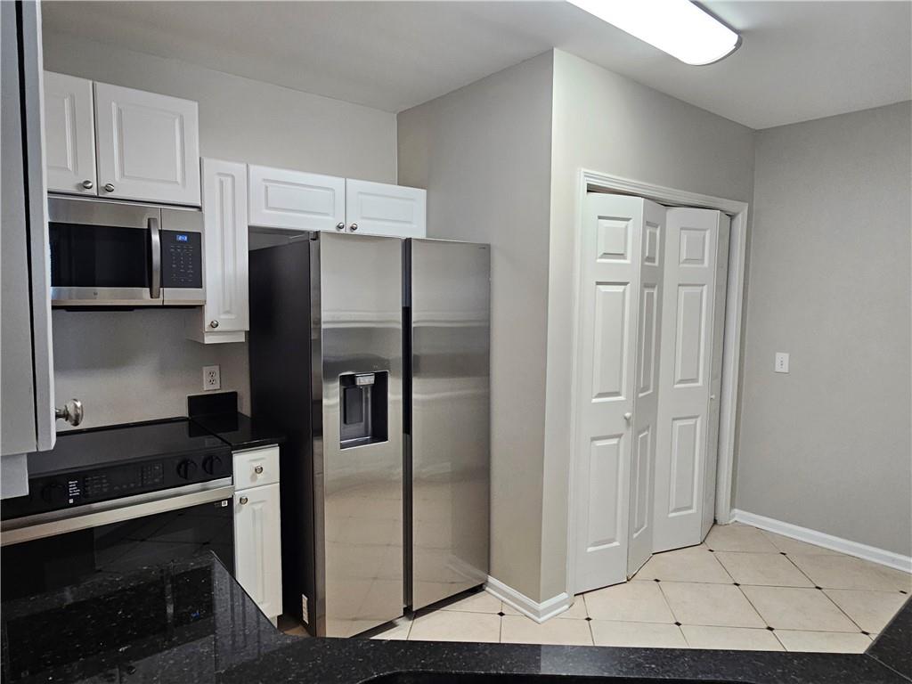 3334 Peachtree Road Northeast, Unit 403 Atlanta, GA 30326 - Photo 14 of 52 a metallic refrigerator freezer sitting in a kitchen