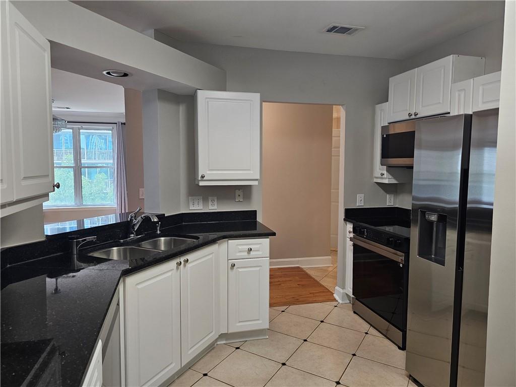 3334 Peachtree Road Northeast, Unit 403 Atlanta, GA 30326 - Photo 15 of 52 a kitchen with a sink stove and refrigerator