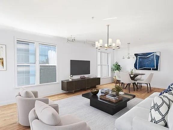 3334 Peachtree Road Northeast, Unit 403 Atlanta, GA 30326 - Photo 2 of 52 a living room with furniture a chandelier and a flat screen tv