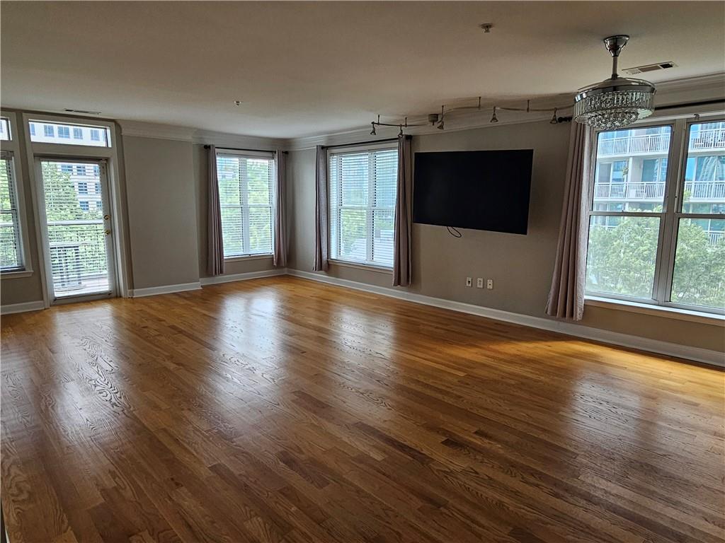 3334 Peachtree Road Northeast, Unit 403 Atlanta, GA 30326 - Photo 27 of 52 an empty room with wooden floor and windows