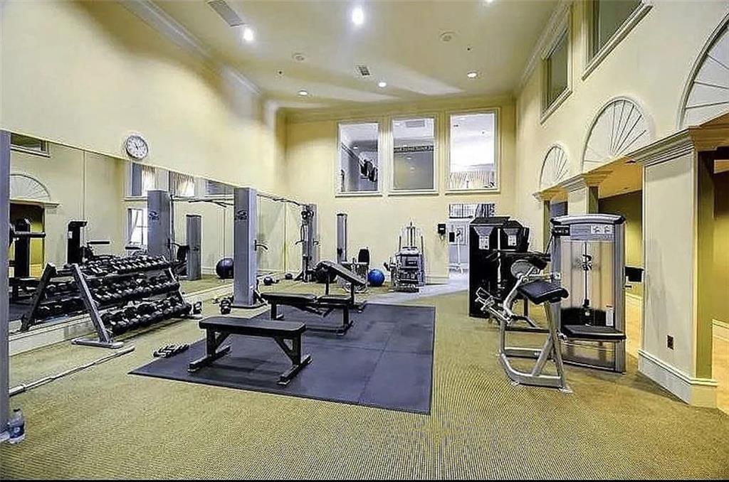 3334 Peachtree Road Northeast, Unit 403 Atlanta, GA 30326 - Photo 38 of 52 a living room with lots of furniture and gym equipment