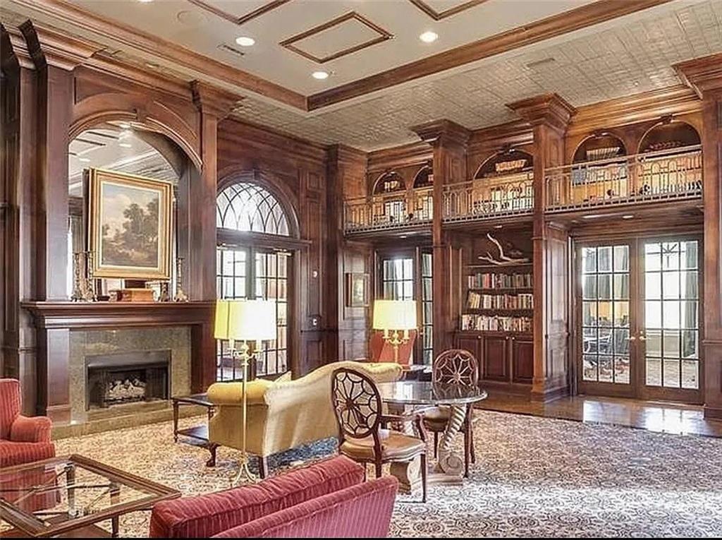 3334 Peachtree Road Northeast, Unit 403 Atlanta, GA 30326 - Photo 44 of 52 a living room with furniture a fireplace and a flat screen tv