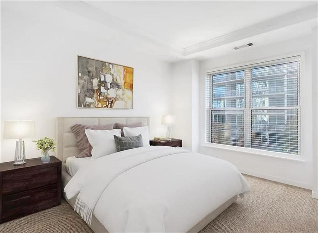 3334 Peachtree Road Northeast, Unit 403 Atlanta, GA 30326 - Photo 7 of 52 a bedroom with a bed and a large window