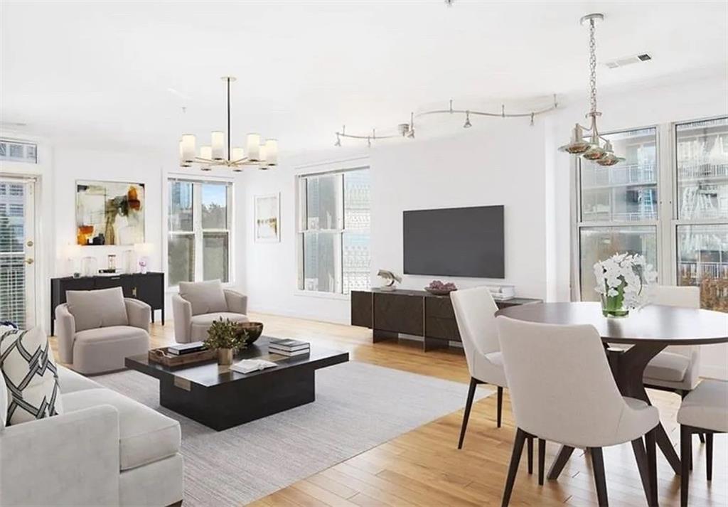 3334 Peachtree Road Northeast, Unit 403 Atlanta, GA 30326 - Photo 8 of 52 a living room with furniture and a chandelier