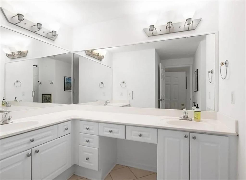 3334 Peachtree Road Northeast, Unit 403 Atlanta, GA 30326 - Photo 10 of 52 a sink with a mirror and vanity