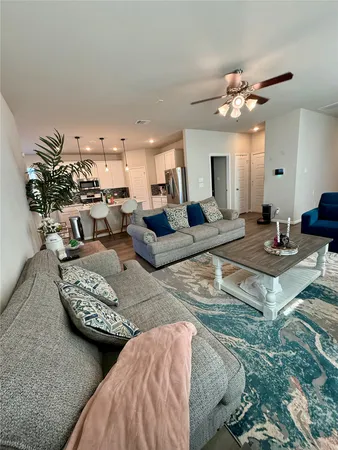a living room with furniture and a chandelier
