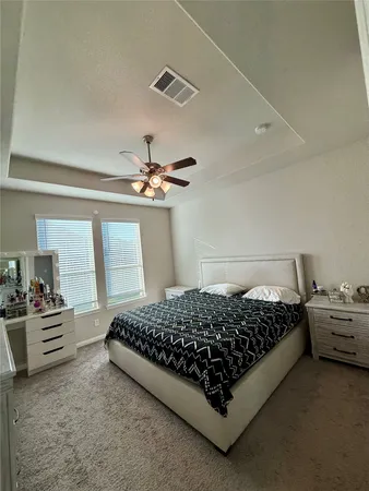 a bedroom with a bed and window