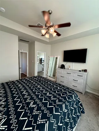 a bedroom with a bed and flat screen tv