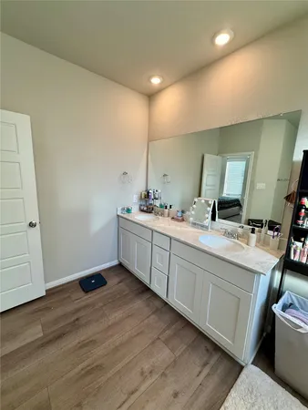 a bathroom with a double vanity sink and mirror
