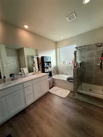 a bathroom with double vanity and a shower