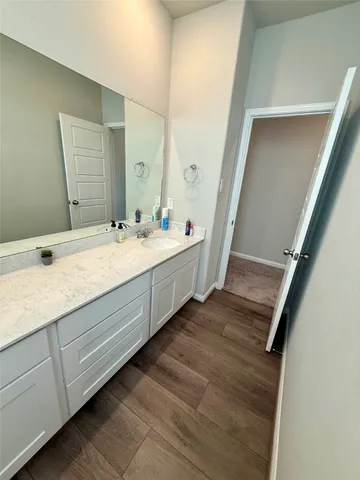 a bathroom with a double vanity sink and a mirror