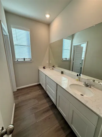 a bathroom with a double vanity sink and a mirror