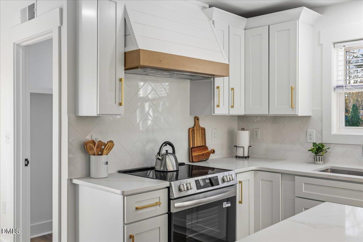 617 North 3rd Street Mebane, NC 27302 - Photo 20 of 50 a kitchen with stainless steel appliances granite countertop a sink stove and cabinets