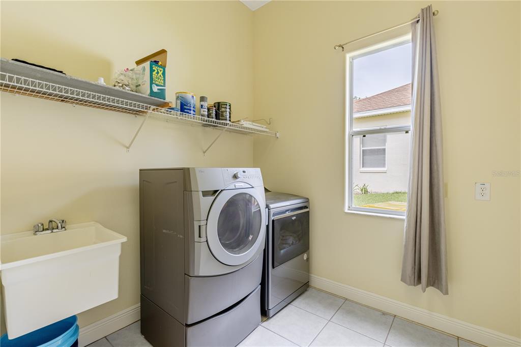 2718 Knightsbridge Road Clermont, FL 34711 - Photo 30 of 72 a utility room with dryer and washer