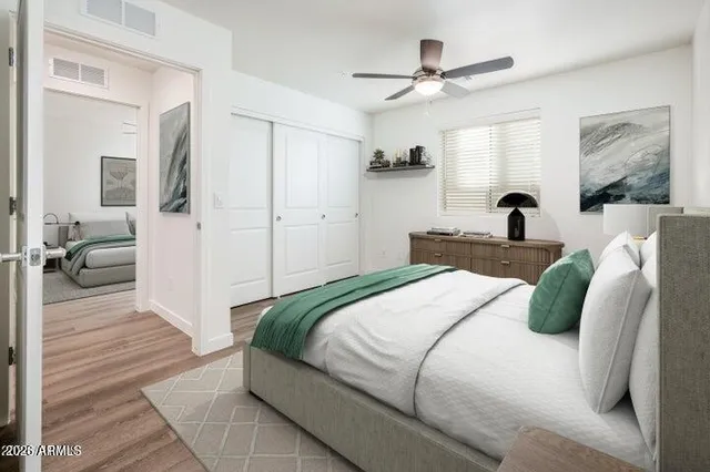 a bedroom with a large bed and a chandelier