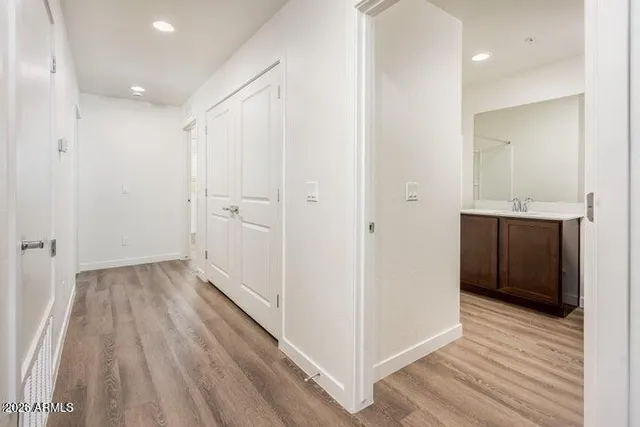 a view of a hallway with wooden floor