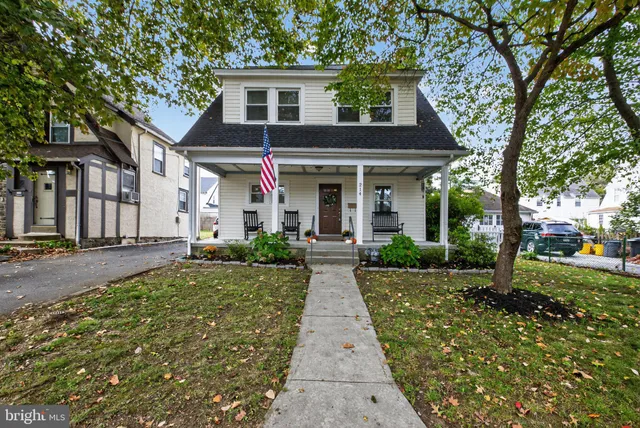 a front view of a house with yard and green space