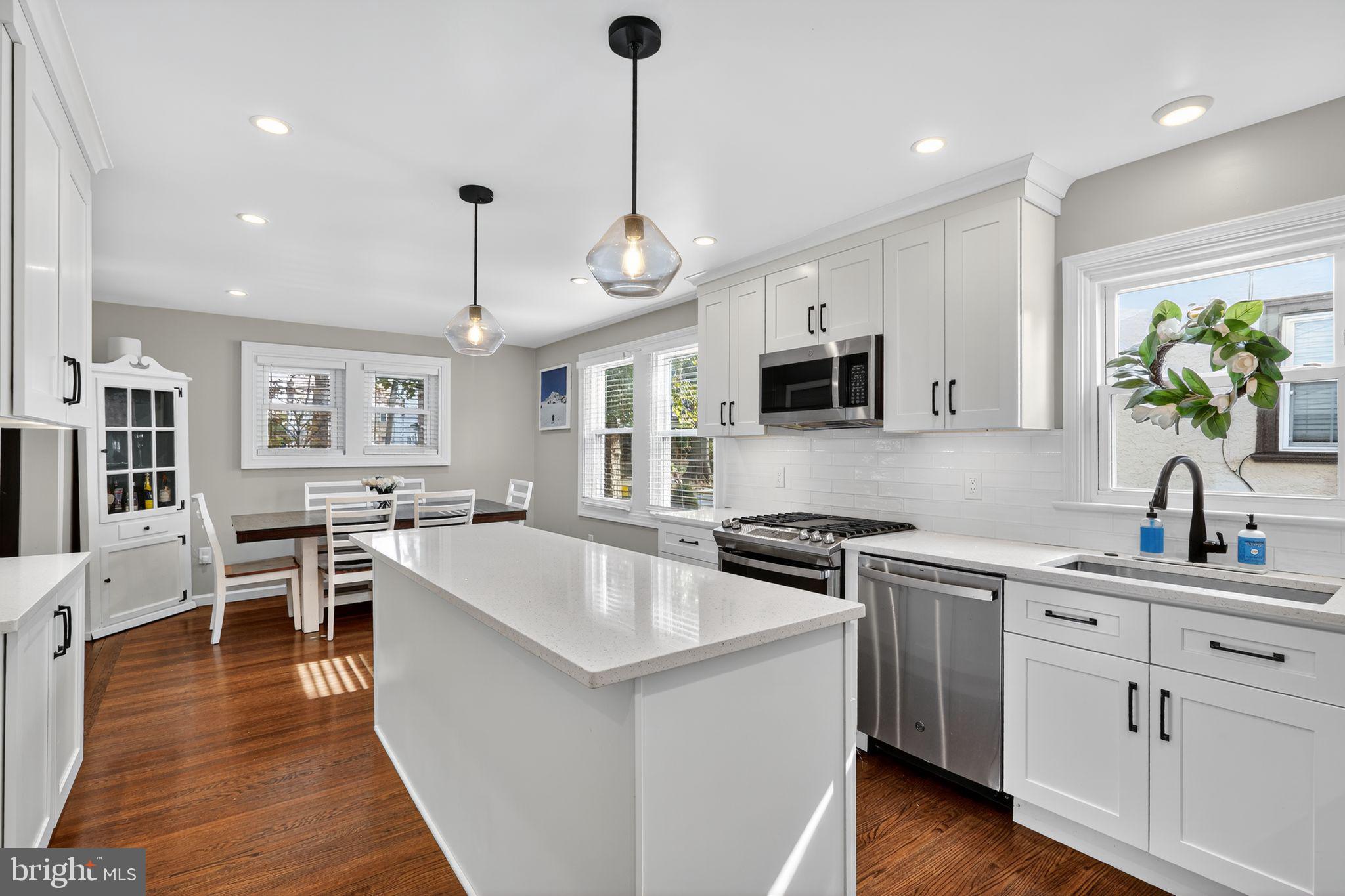 214 Lynbrooke Road Springfield, PA 19064 - Photo 17 of 42 a kitchen with stainless steel appliances granite countertop a sink stove and refrigerator