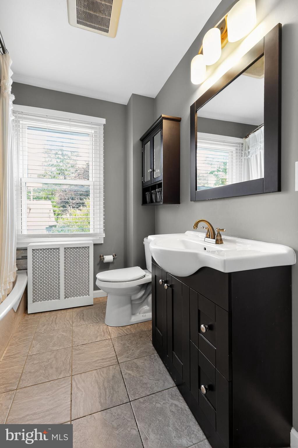 214 Lynbrooke Road Springfield, PA 19064 - Photo 28 of 42 a bathroom with a sink vanity and a mirror