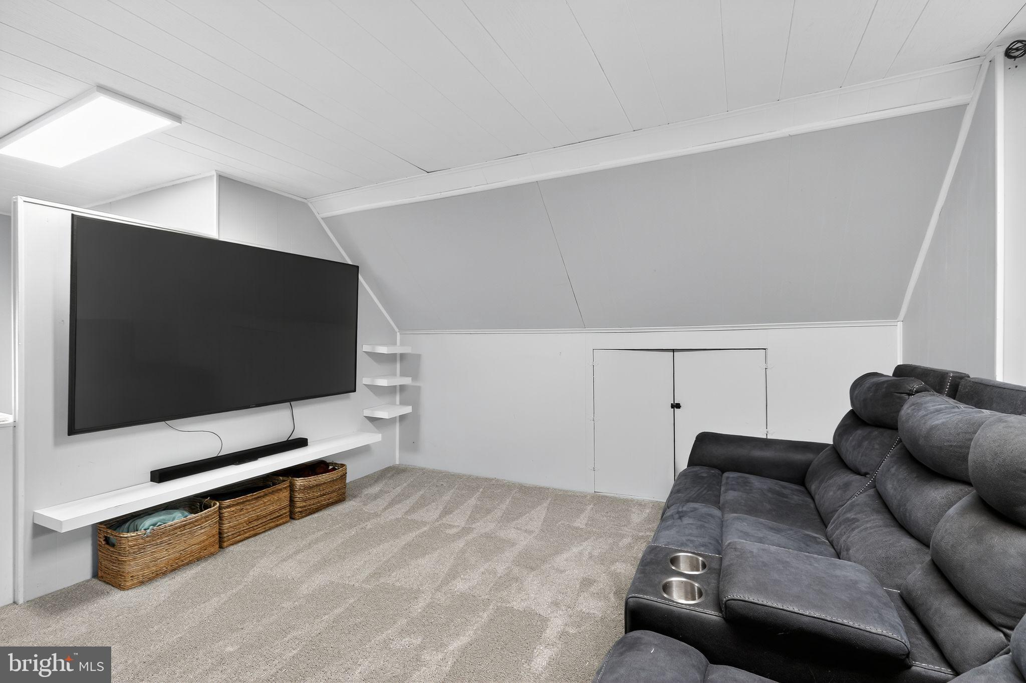 214 Lynbrooke Road Springfield, PA 19064 - Photo 32 of 42 a living room with furniture and a flat screen tv