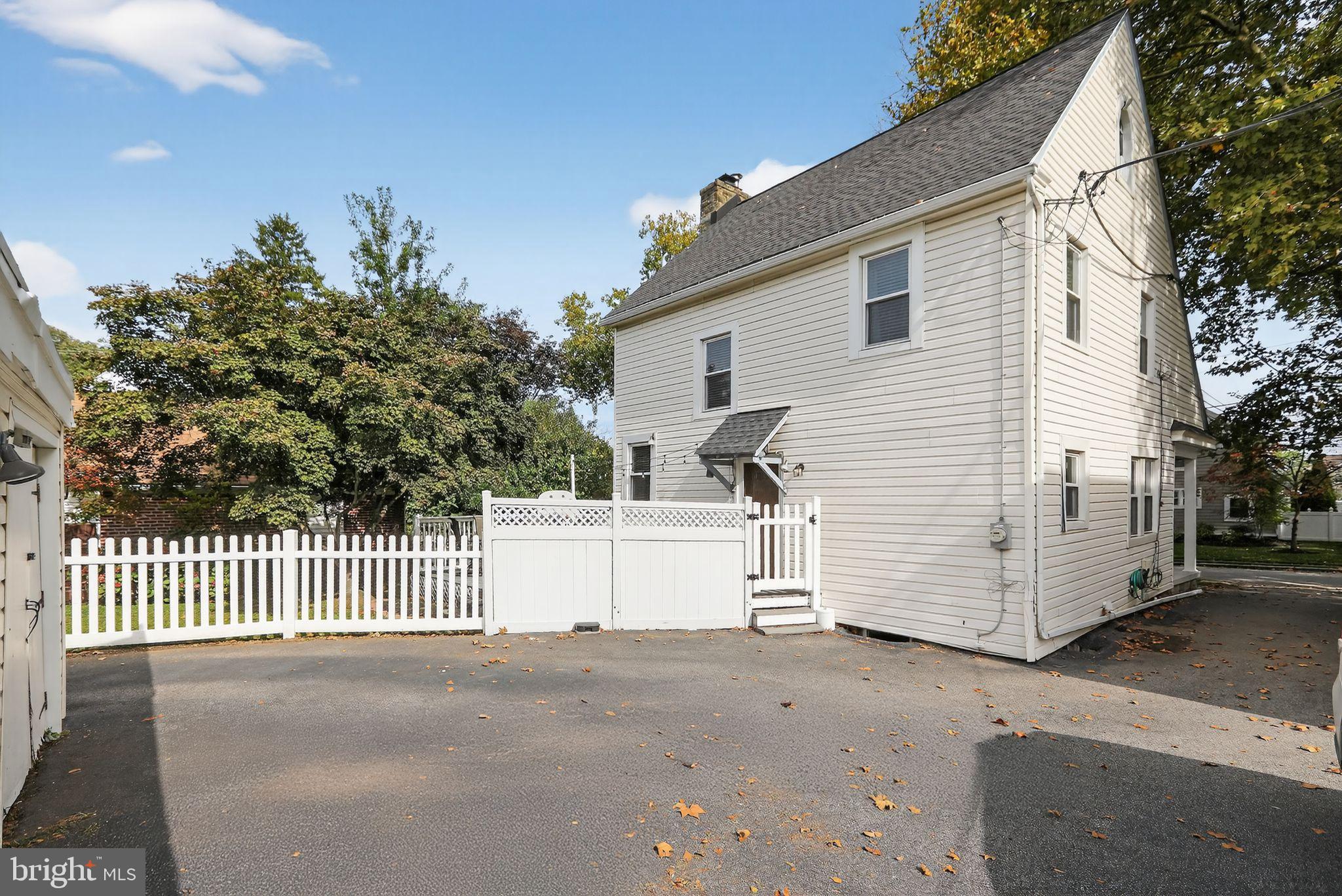 214 Lynbrooke Road Springfield, PA 19064 - Photo 36 of 42 a view of a white house with a street