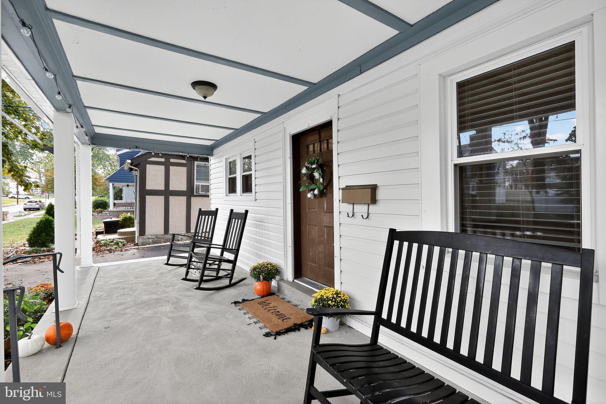 214 Lynbrooke Road Springfield, PA 19064 - Photo 5 of 42 a view of a porch with chairs and floor to ceiling window