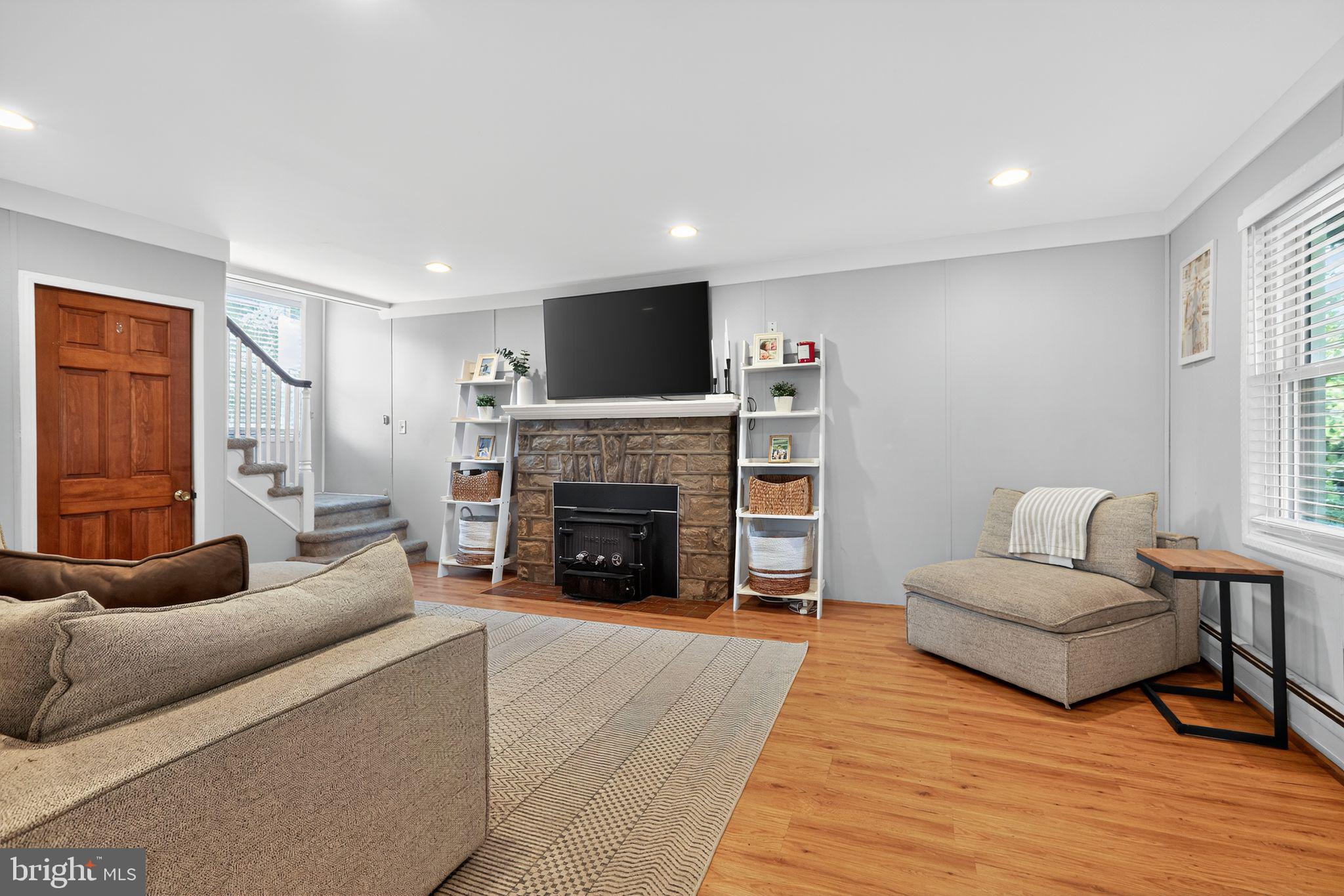 214 Lynbrooke Road Springfield, PA 19064 - Photo 7 of 42 a living room with furniture and a fireplace
