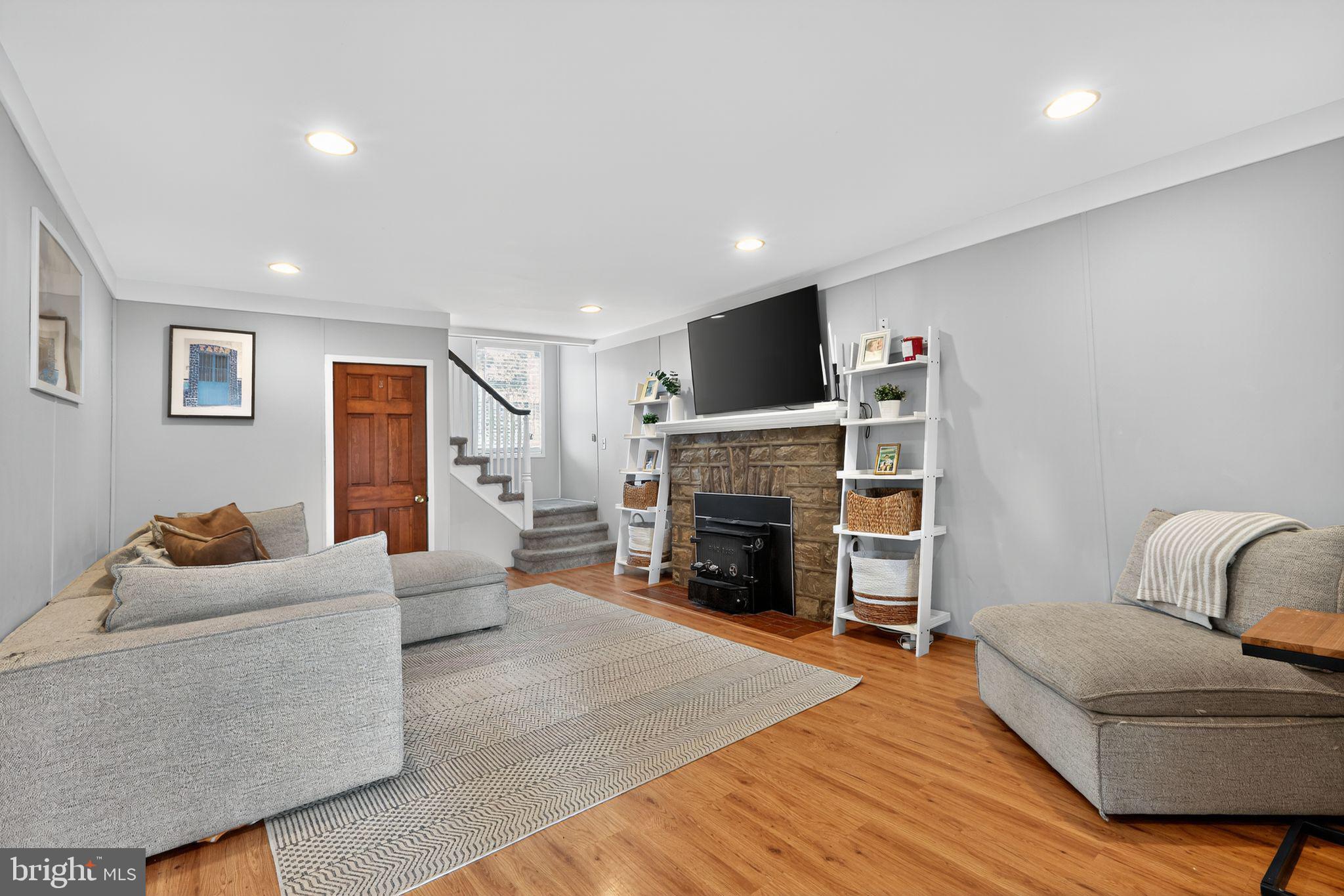 214 Lynbrooke Road Springfield, PA 19064 - Photo 8 of 42 a living room with furniture and a fireplace