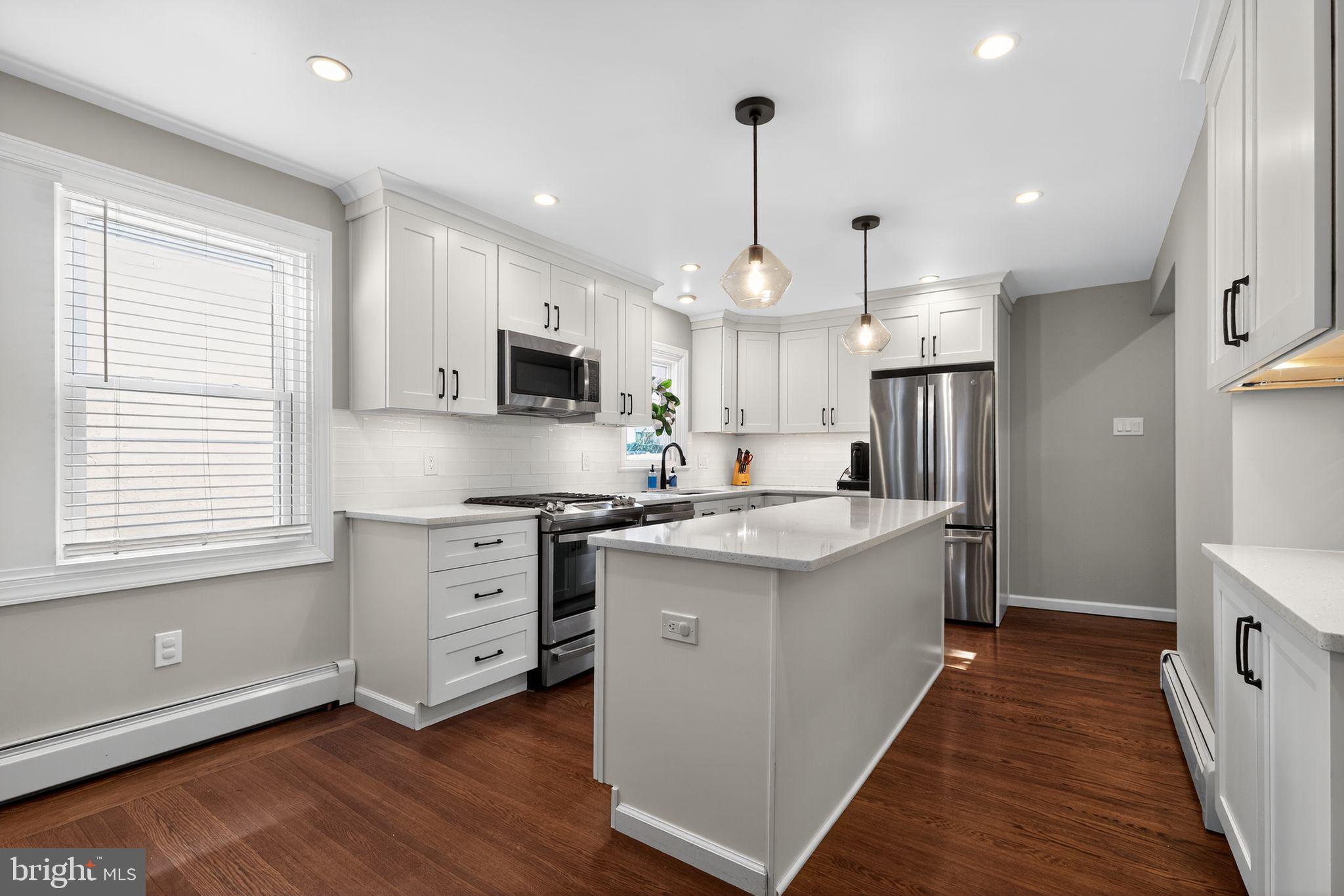 214 Lynbrooke Road Springfield, PA 19064 - Photo 10 of 42 a kitchen with stainless steel appliances granite countertop a sink stove and refrigerator