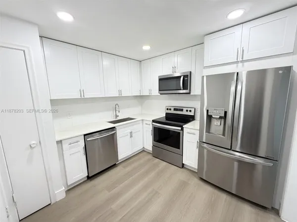 a kitchen with a refrigerator stove and microwave