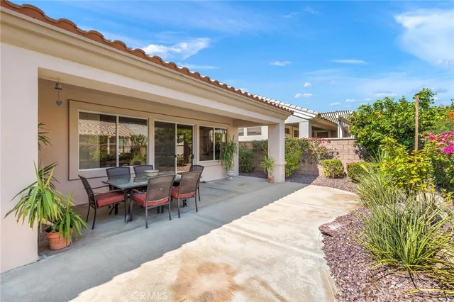 a view of a house with backyard and sitting area