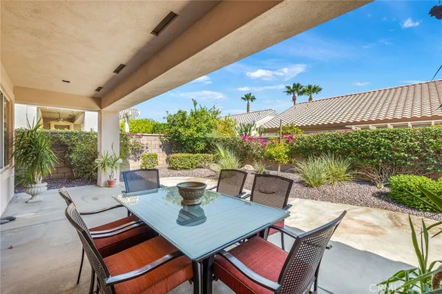 a outdoor dining space with furniture and garden view