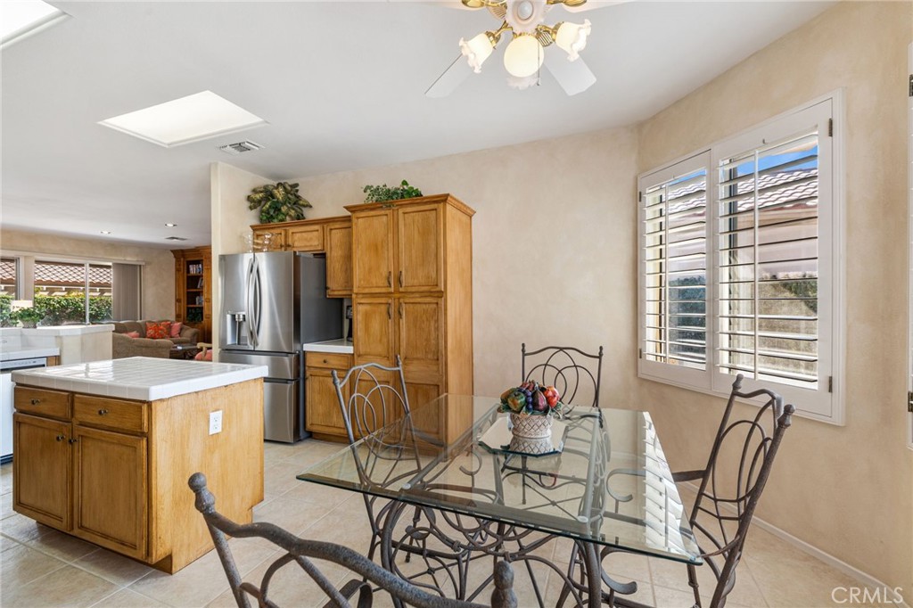78770 Golden Reed Drive Palm Desert, CA 92211 - Photo 14 of 36 a view of a dining room with furniture and a chandelier