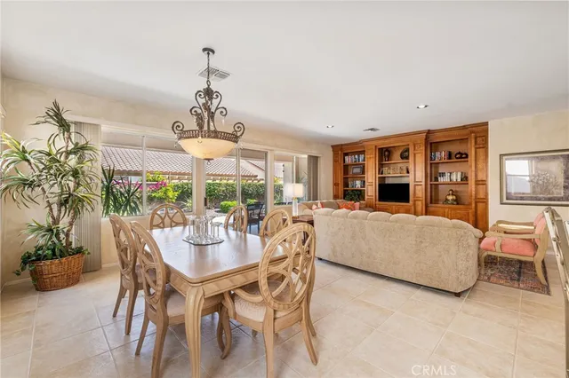 a dining room with furniture a chandelier and a rug