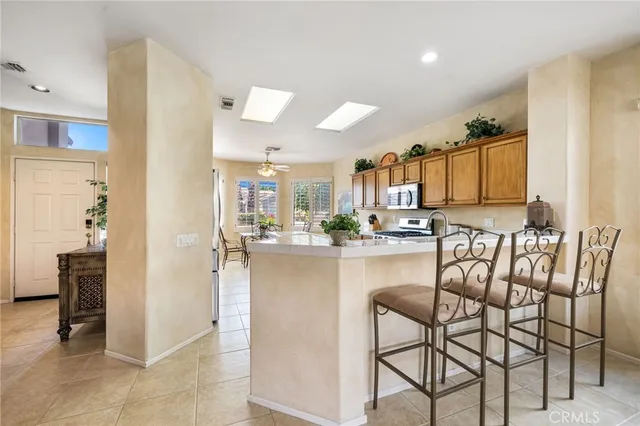 a kitchen with stainless steel appliances granite countertop a refrigerator and microwave