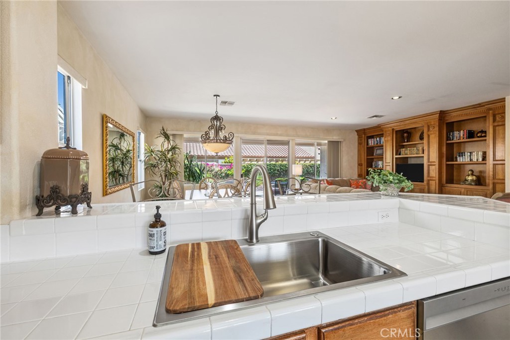 78770 Golden Reed Drive Palm Desert, CA 92211 - Photo 19 of 36 a kitchen with granite countertop a sink and a large window