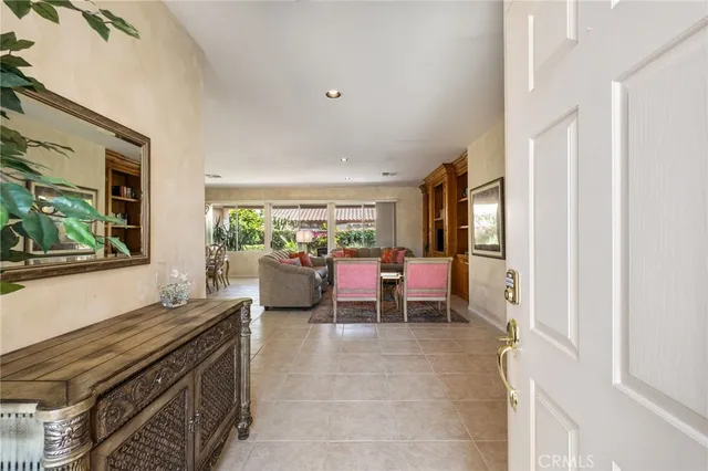 a living room with chairs and window