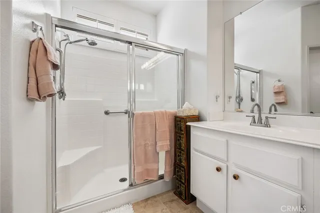 a bathroom with a shower sink and mirror
