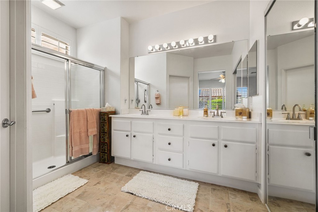 78770 Golden Reed Drive Palm Desert, CA 92211 - Photo 29 of 36 a spacious bathroom with a double vanity sink a mirror and shower