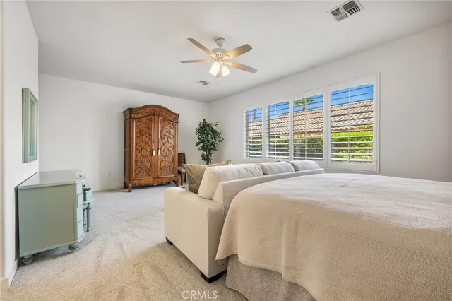 a bed room with a bed and a chandelier