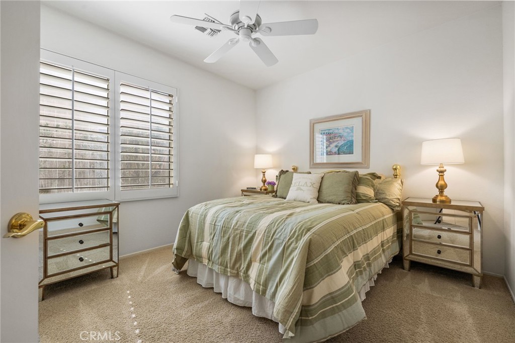 78770 Golden Reed Drive Palm Desert, CA 92211 - Photo 33 of 36 a spacious bedroom with a bed and a window