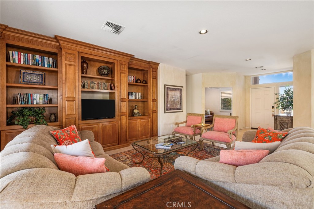 78770 Golden Reed Drive Palm Desert, CA 92211 - Photo 10 of 36 a living room with furniture potted plant and a bookshelf