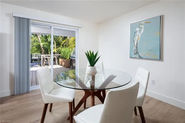 a dining room with furniture and wooden floor