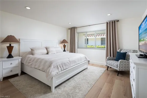 a bedroom with a bed and a couch