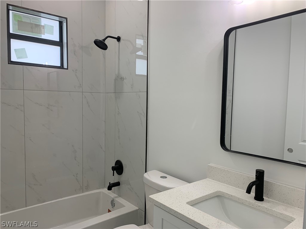 526 Raintree Street East Lehigh Acres, FL 33974 - Photo 17 of 21 a bathroom with a sink toilet and shower
